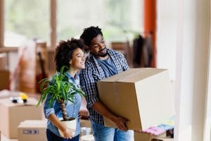 young couple holding moving boxes 1.format jpeg
